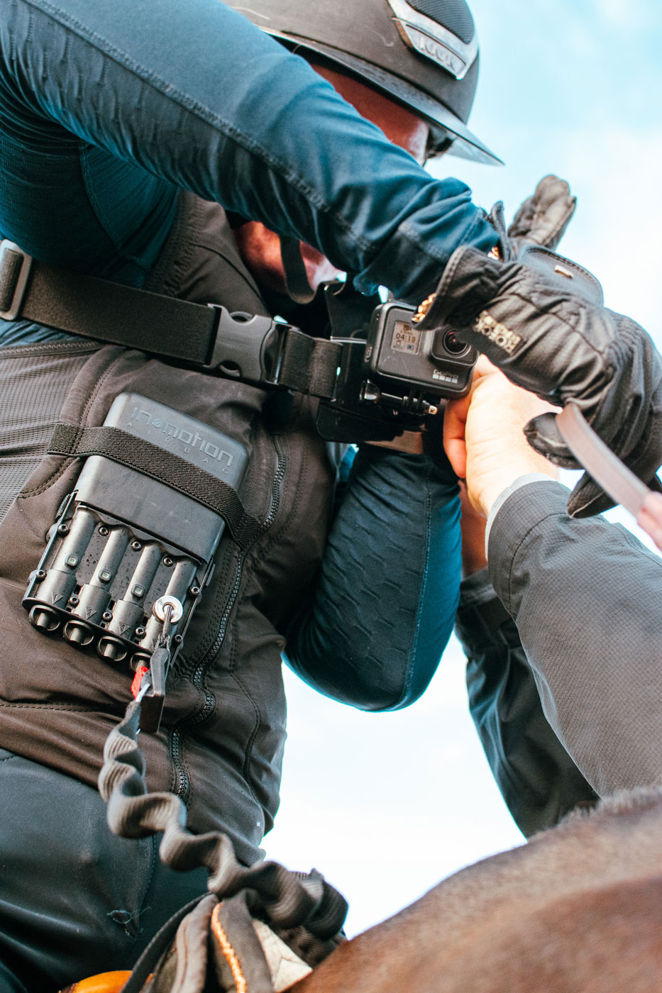 Me mounting a GoPro on Hilma riding Mynta. What you see below the GoPro is the dead-man-trigger and gas canisters in the security vest Hilma was using.